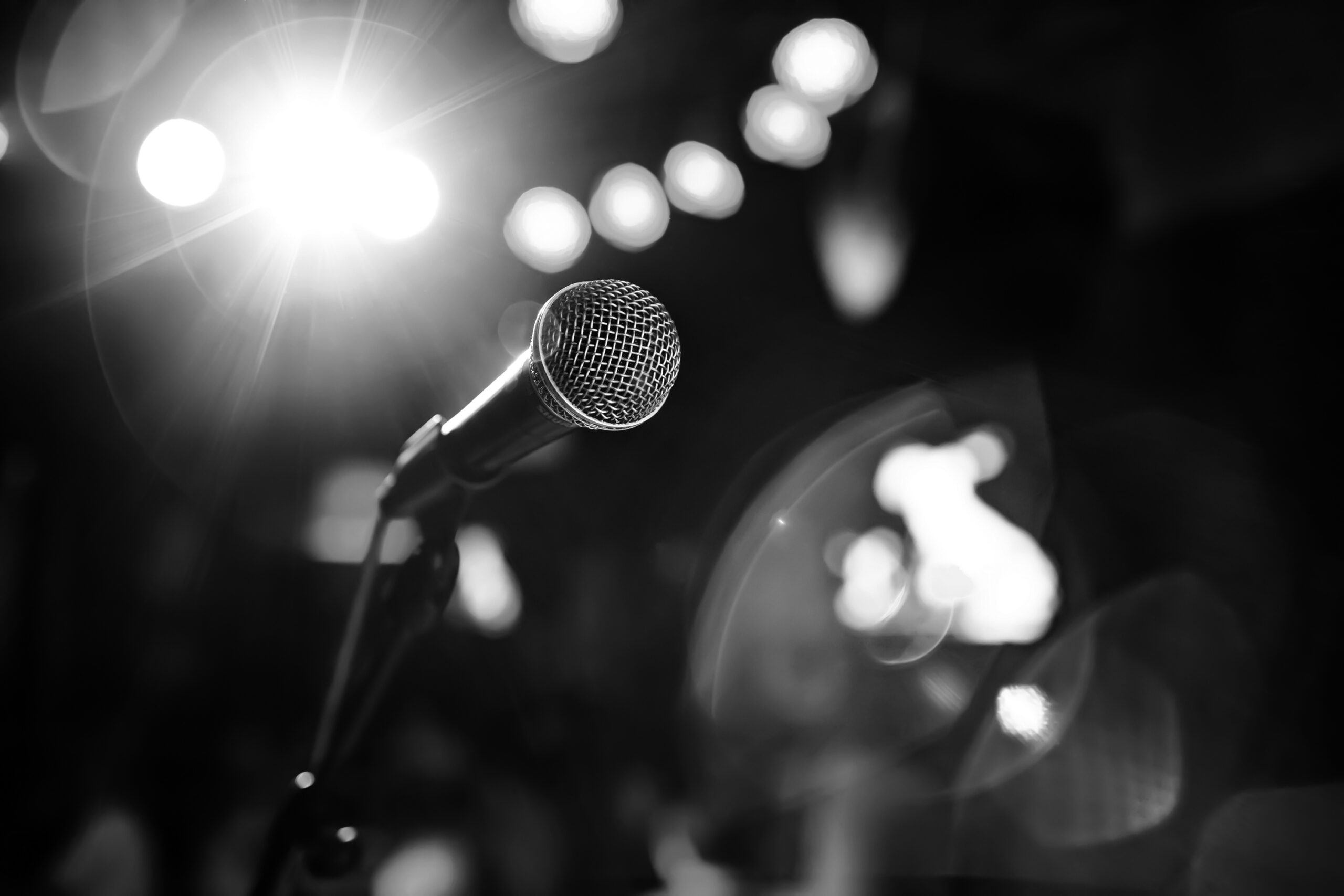 Public performance on stage Microphone on stage against a background of auditorium. Shallow depth of field. Public performance on stage.